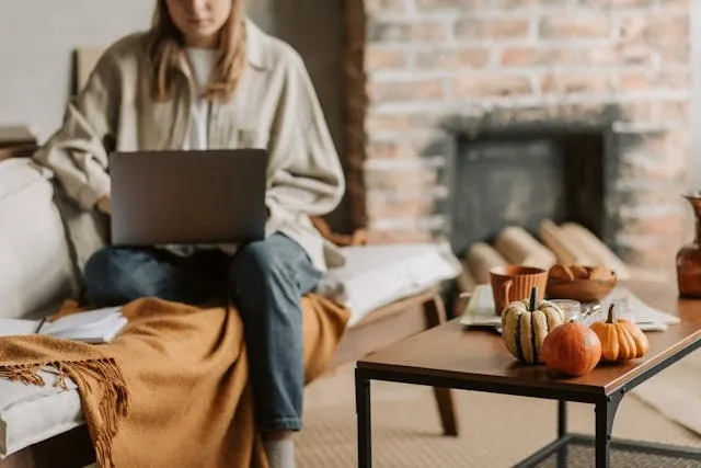 a person with a laptop beside a coffee table for coffee table cover ideas