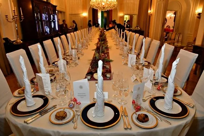 a large oval table dressed for a banquet for table top cover ideas