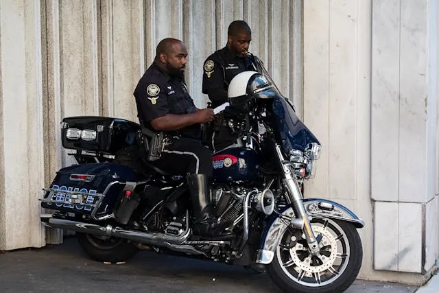 two police officers beside a motorbike for best police patches