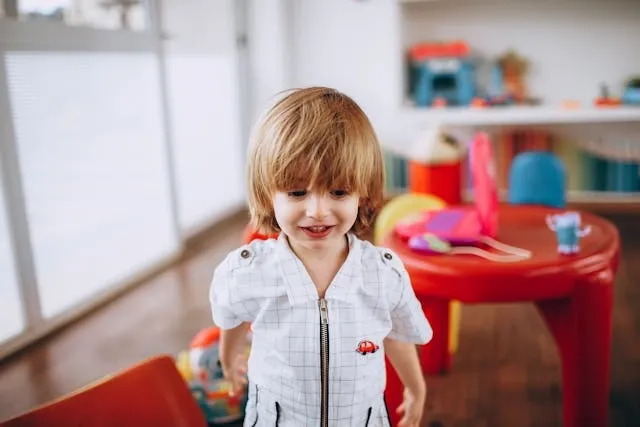 a child wearing a shirt with a patch for how to sew a patch onto a shirt