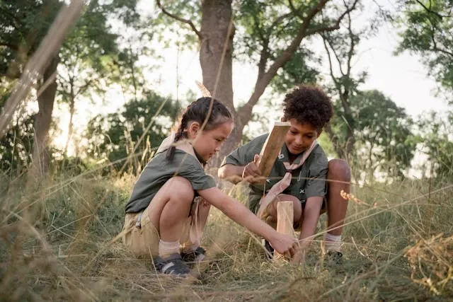 two young scouts in a field for cub scout patch placement