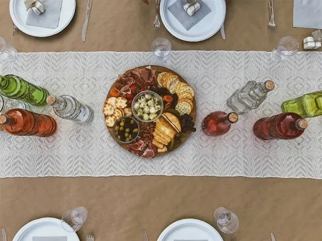 a table runner with serving dish and bottles for table runner too long