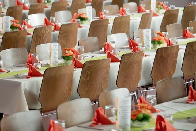 rows of tables and chairs for dining tables at a corporate event for corporate event planning