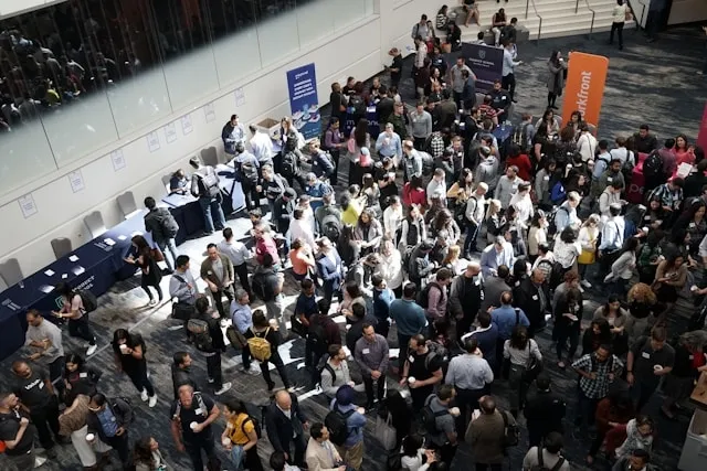 an overhead view of a busy room at a corporate event for corporate event planning checklist