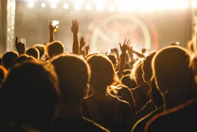 an audience gesturing towards a stage for gala event planning checklist