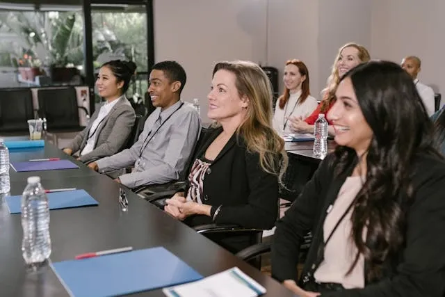 some smiling people in a corporate environment for employee appreciation gifts