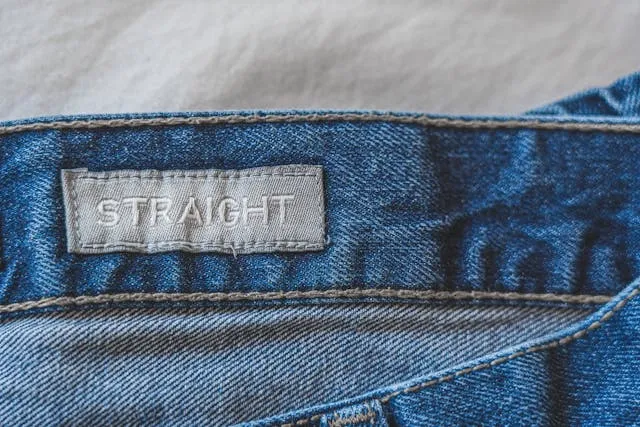 a clothing tag in the waistband of some jeans for how to attach tags to clothes