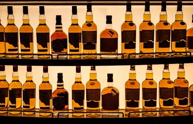 shelves filled with a display of liquor bottles for home bar essentials