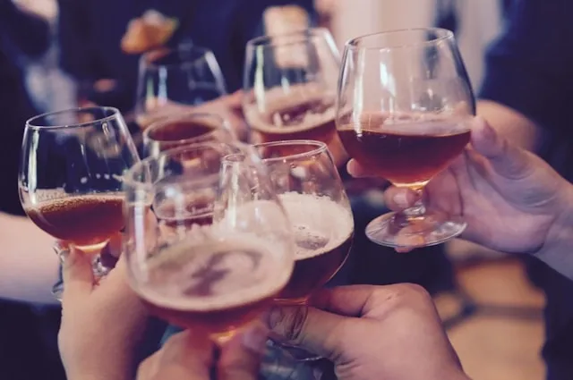 a group of glasses being raised for a toast for home bar essentials