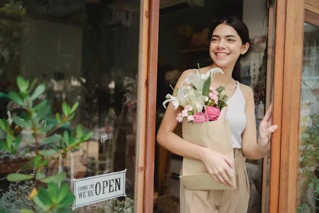 a smiling person standing in the door of an inviting retail store for retail store interior design