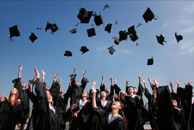 a crowd of graduates throwing their caps in the air for graduation decorations ideas