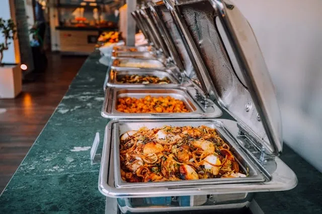 a buffet-style food table for catering for 50 guests on a budget