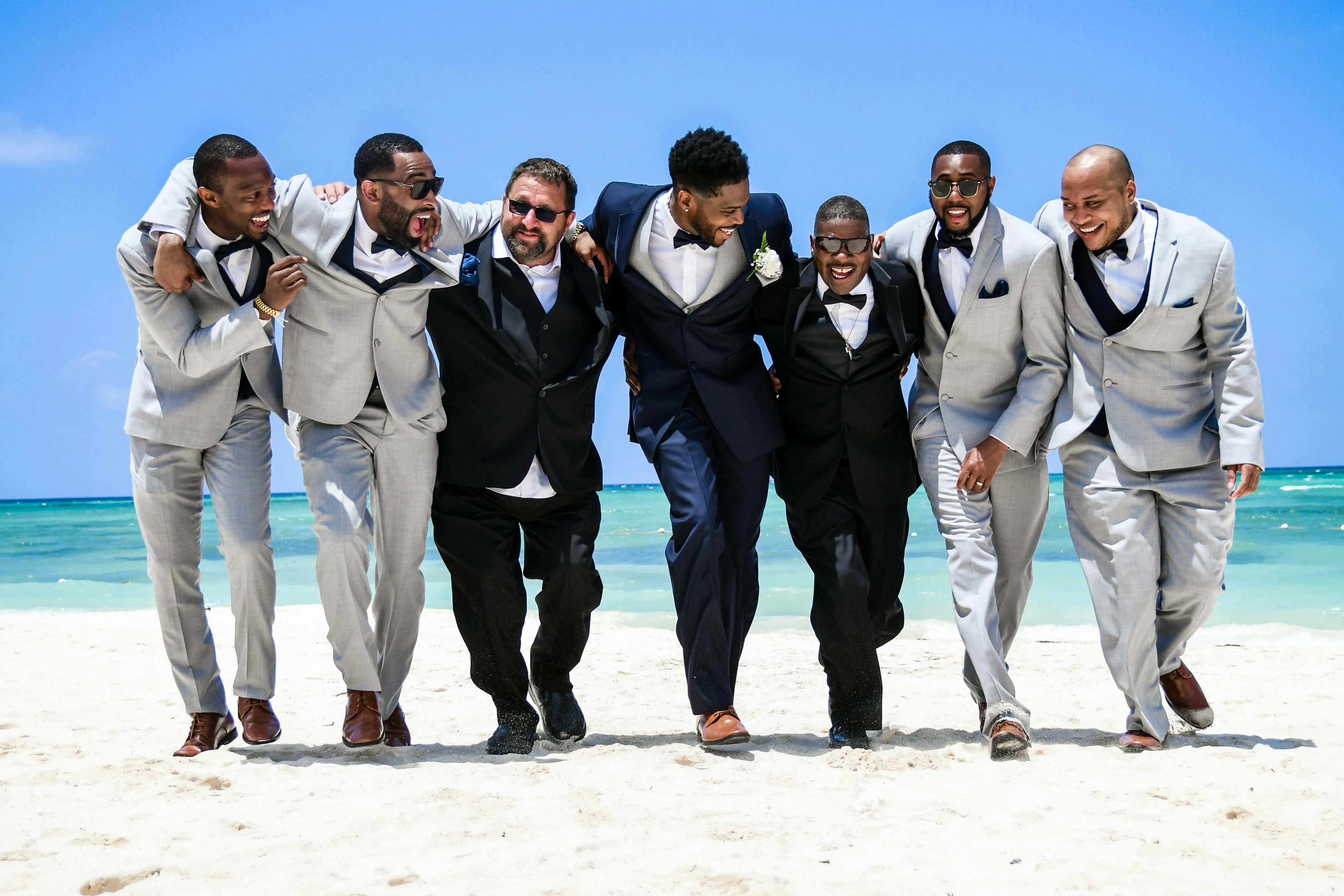 a group of men on a beach for bachelor party checklist