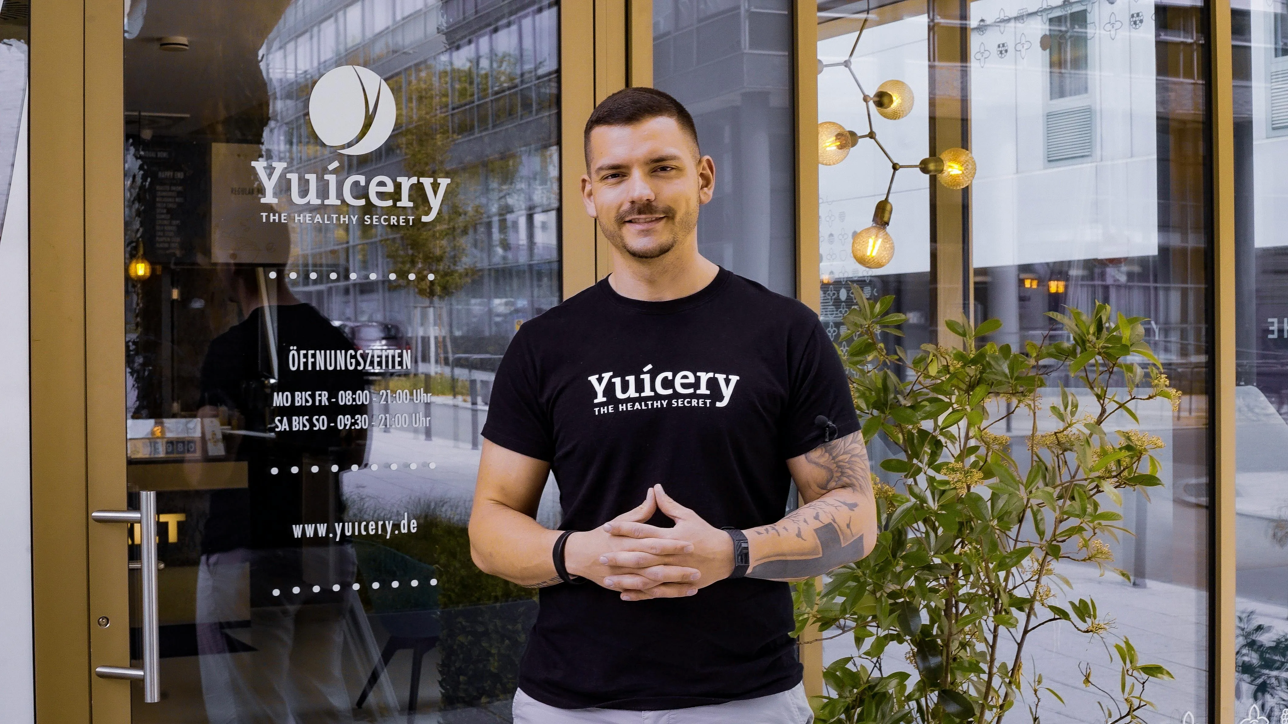 a person posing for a picture outside their restaurant for restaurant branding ideas