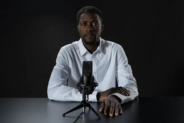 a person sitting in front of a microphone for podcast background ideas