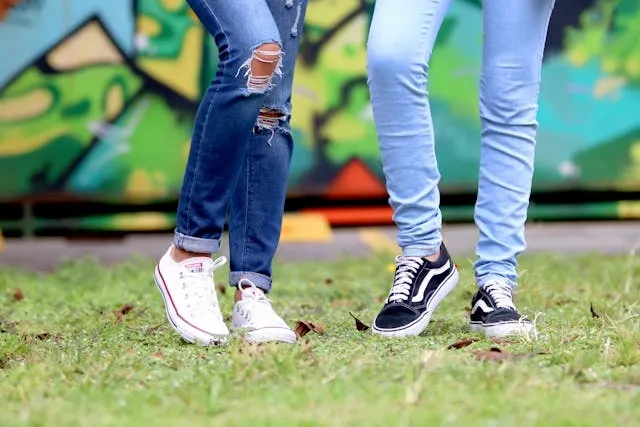 two pairs of legs wearing jeans for how to use iron on patches for jeans