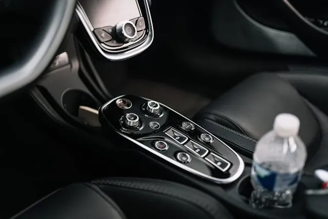 a vehicle cup holder with a plastic water bottle inside it for what are car coasters