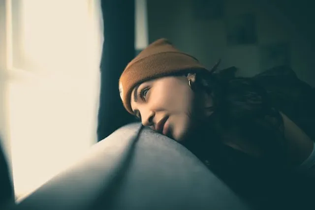 a woman wearing a brown beanie hat for iron patch onto hat