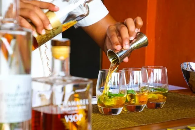 a person preparing some cocktails for what are the essential items needed to bartend