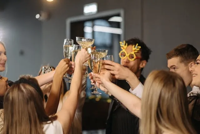 people raising a toast at a party for how many cocktail tables for 100 guests