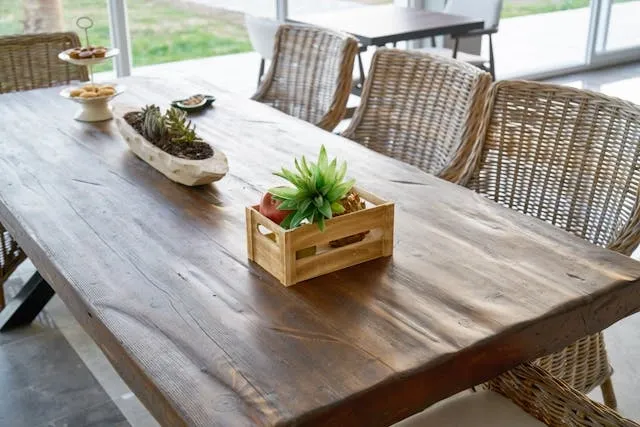 a wooden table with rattan seats for how many people can sit at a 6-foot table