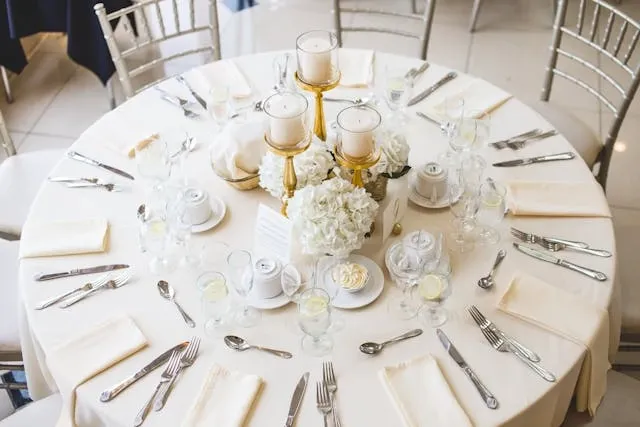 a round table decorated with flowers and candles for event table decoration ideas