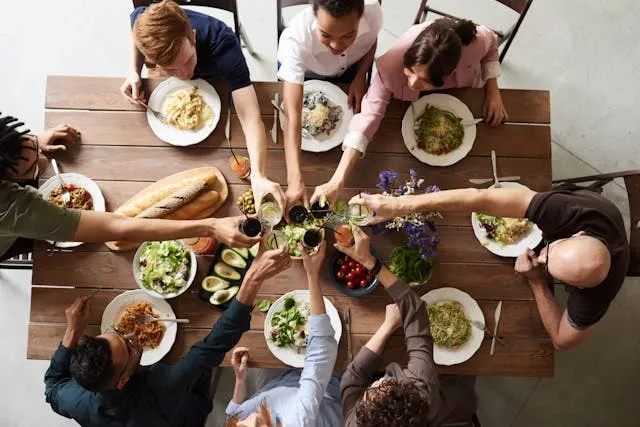 an overhead view of 8 people sitting around a table for how many people can sit at a 6-foot table