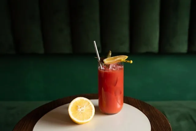 a red cocktail on a small round table for cocktail table setup