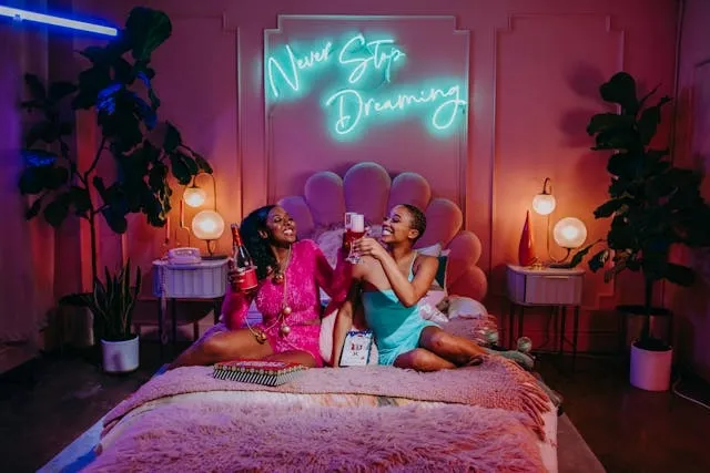 two women in a bedroom with lots of pink design elements for neon pink aesthetic