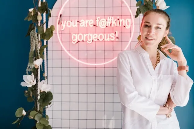 a woman standing beside a pink neon sign for nail salon sign ideas a woman standing beside a pink neon sign for nail salon sign ideas