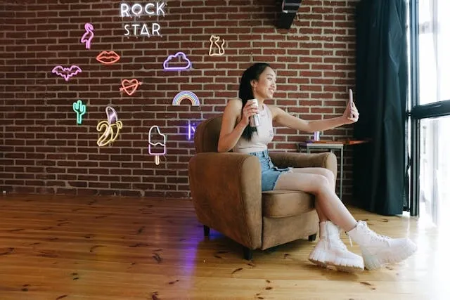 a woman taking a selfie for how to start a neon sign business a woman taking a selfie for how to start a neon sign business