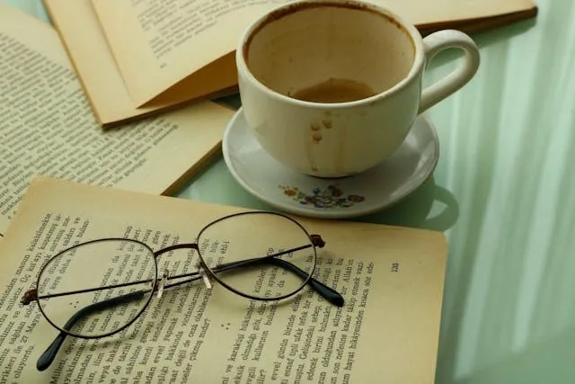 a white ceramic mug next to a book and glasses for how to get coffee stains out of mugs a white ceramic mug next to a book and glasses for how to get coffee stains out of mugs