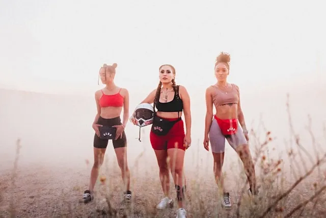 three women in athletic outfits with fanny packs for how to wear a belt bag three women in athletic outfits with fanny packs for how to wear a belt bag