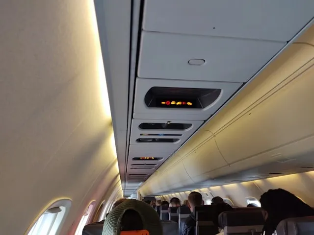 an airplane aisle and passengers for is a backpack a personal item an airplane aisle and passengers for is a backpack a personal item