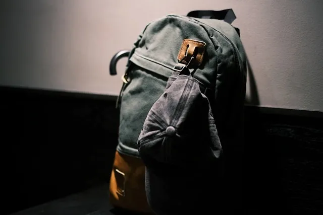 a backpack and hat leaning against a wall for is a backpack a personal item a backpack and hat leaning against a wall for is a backpack a personal item