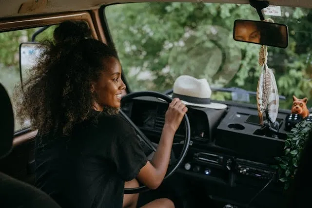woman in black shirt driving a vehicle for is it illegal to hang air freshener in car woman in black shirt driving a vehicle for is it illegal to hang air freshener in car