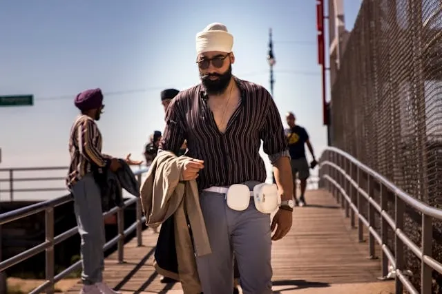 a bearded man on a walkway for are fanny packs back in style