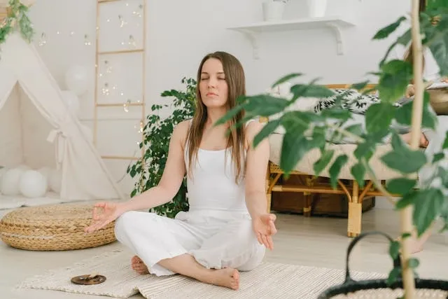 a woman meditating indoors for how to get rid of air freshener smell a woman meditating indoors for how to get rid of air freshener smell