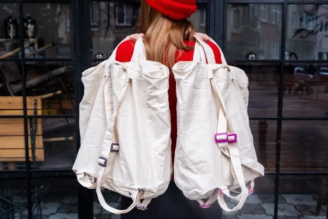 a woman holding canvas backpacks for how to make backpack straps longer a woman holding canvas backpacks for how to make backpack straps longer