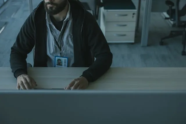 a man sitting at a desk for how to fix a badge reel a man sitting at a desk for how to fix a badge reel